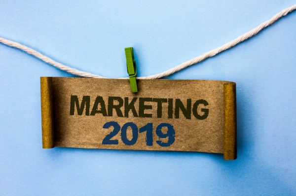 Handwriting text Marketing 2019. Concept meaning New Year Market Strategies Fresh start Advertising Ideas written Cardboard Paper hanging on rope the plain background Clip.